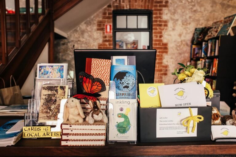 An inviting bookshop counter with various gifts, cards, and books on display.